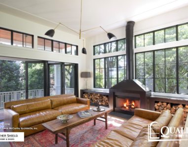 Living room with floor to ceiling windows on both walls